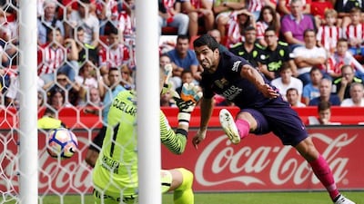 Barcelona forward Luis Suarez scores the opening goal. Jose Luis Cereijido / EPA