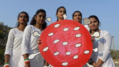 A group of young people hold a coronavirus-themed board during the Republic Day celebrations in Secunderabad, the twin city of Hyderabad. AFP