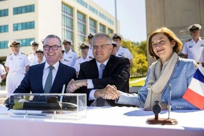 French Defence Minister Florence Parly, right, shook hands on the submarine deal with Mr Morrison and her Australian counterpart Christopher Pyne, left, in 2019. AFP