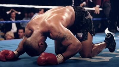 Mike Tyson falls to his knees in celebration