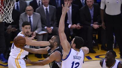 San Antonio Spurs guard Tony Parker goes the basket against Golden State Warriors centre Andrew Bogut during their NBA contest. John G Mabanglo / EPA