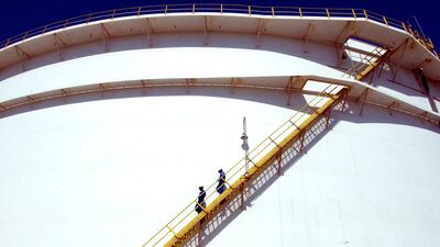 Oil technicians at a giant tank at Enoc’s Jebel Ali refinery. The company is considering adding 75,000 bpd to its current 140,000 bpd capacity. Kamran Jebreili / AP Photo