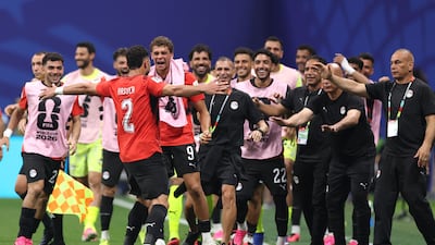 Yasser Ibrahim celebrates with his Egypt teammates and coaching staff after scoring. AFP