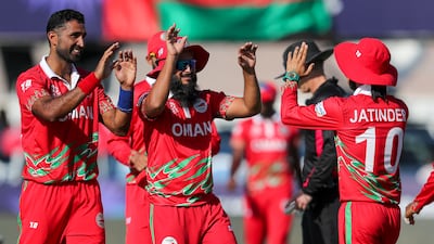 Oman's Jatinder Singh, right, is congratulated by teammates after taking a catch against Papua New Guinea. AP