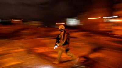 An Israeli soldier walks during clashes with Palestinian protesters in the occupied West Bank city of Ramallah on December 11, 2018. AFP