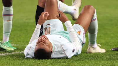 Kylian Mbappe goes down injured after scoring for France. Reuters