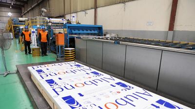 Above, workers making sheets at the Alubond’s facility at Hamiryah Free Zone in Sharjah. Pawan Singh / The National