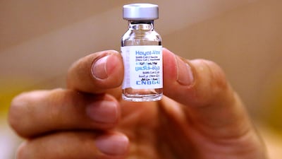 A health worker holds up a vial of the UAE-made 'Hayat-Vax' Covid-19 vaccine, a locally-produced version of China's Sinopharm vaccine, at a vaccination centre in Iran's capital Tehran. AFP