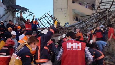 Members of rescue services work at the site of the collapsed building in Malatya, Turkey, on Tuesday. AFP