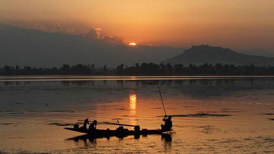 A Kashmiri fisherman fishes during sunset at the Dal Lake in Srinagar, Kashmir. Mukhtar Khan / AP Photo