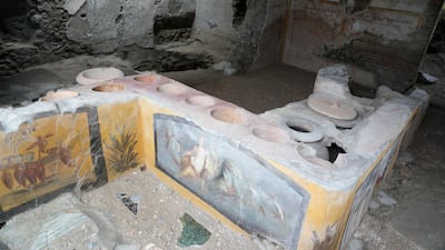 A thermopolium, a commercial establishment where it was possible to purchase ready-to-eat food, is seen inside the Pompeii archaeological site, southern Italy, Tuesday, Feb. 15, 2022. In a few horrible hours, Pompeii went from being a vibrant city to a dead one, smothered by a furious volcanic eruption in 79 AD. Then in this century, Pompeii appeared alarmingly on the precipice of a second death, assailed by decades of neglect, mismanagement and scanty systematic maintenance of heavily visited ruins. (AP Photo / Gregorio Borgia)