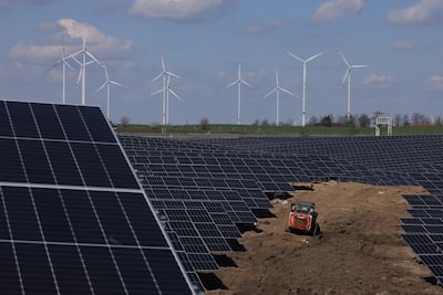A solar energy park with wind turbines in the background near Prenzlau, Germany. The supply of critical metals and minerals is essential on the road to net zero. Getty Images
