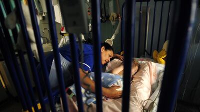 A nurse comforts a patient at Great Ormond Street Hospital for Children. Dylan Martinez / Reuters
