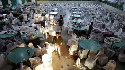 Workers inspect a damaged wedding hall after a blast in Kabul, Afghanistan. Reuters