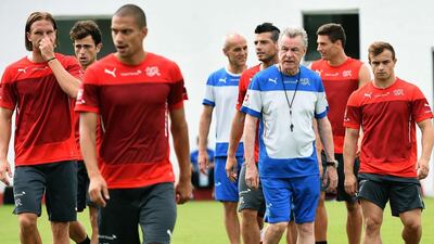 Switzerland coach Ottmat Hitzfeld, third from right, said he would retire from coaching at the end of the 2014 World Cup. The Swiss are hoping to delay that plan for at least one more game. Anne-Christine Pouioulat / AFP