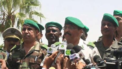 General Mohammed Ould Abdel Aziz, middle, Mauritania's junta leader, answers questions while flanked by his supporters.