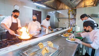 Feby Baguisa at work in the kitchen along with her staff.