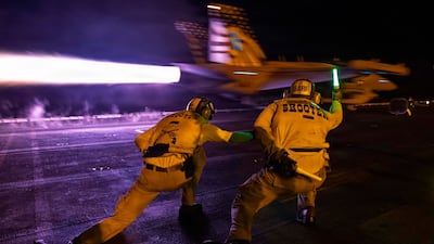 An E/A-18G aircraft launches from the flight deck of USS George H.W. Bush (CVN 77) during night flight operations while the ship supports enforcement of the U.S. blockade against Iran in the Arabian Sea. As of Sept. 7, CENTCOM forces have redirected 94 commercial vessels, disabled 3 and boarded 2 to ensure complete compliance with the blockade.