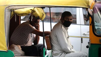An Indian auto rickshaw driver wears a mask during heavy smog in New Delhi, India. EPA
