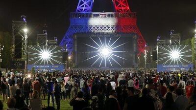 The Eiffel Tower is lit in the French colours during the opening game of the Uefa Euro 2016 between France and Romania in the fan zone at the Eiffel Tower in Paris, France, 10 June 2016. France beat Romania 2-1. Ian Langsdon / EPA