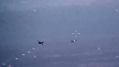 Russian military SU-34 and SU-35 aircraft release flares in the flight path of a US Air Force MQ-9 Reaper drone over Syria. AP