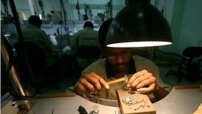 W A craftsman works on jewellery at the Damas factory in Dubai. Shares of Damas have surged more than 130 per cent recently. Pawan Singh / The National