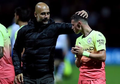 Manchester City manager Pep Guardiola congratulates Phil Foden after beating Preston on Wednesday. PA