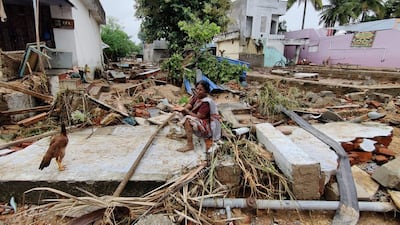 A woman who survived flooding in the Kadapa district of Andhra Pradesh state surveys the wreckage. Photo: Srinivaslu Konda