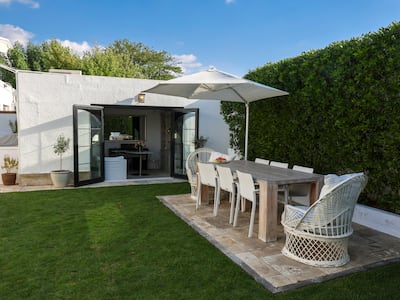 The family can enjoy al fresco dining in the lush garden area during the cooler months. Victor Besa / The National