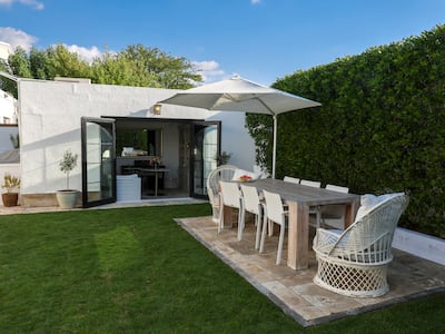 The family can enjoy al fresco dining in the lush garden area during the cooler months. Victor Besa / The National