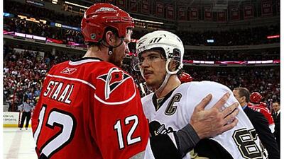 Sidney Crosby, right, captain of the Pittsburgh Penguins is congratulated by Carolina's Eric Staal after their 4-1 win in Game Four.