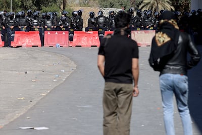 Iraqi security forces stand guard as protesters approach the Green Zone in Baghdad, where the US embassy is located. AFP