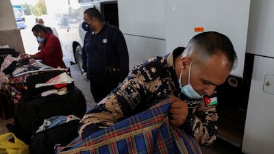 A Jordanian customs officer inspects travellers' belongings at the Jaber crossing with Syria. Meagre cross-border trade reflects overarching political problems. Reuters