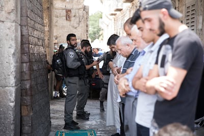 Israeli border police stand on duty as Palestinians pray at the Lion's Gate entrance to the Old City of Jerusalem, near to Haram Al Sharif, on July 25, 2017. Abir Sultan / EPA