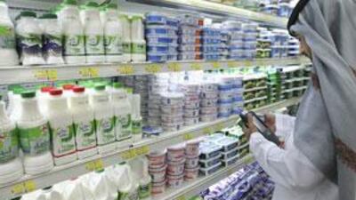 A food inspector examines dairy produce in a supermarket in Abu Dhabi.