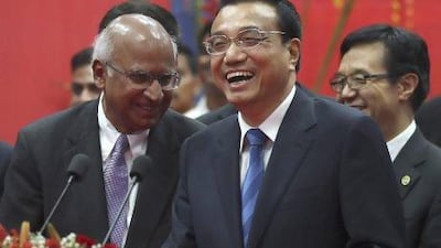Chinese Premier Li Keqiang, center, interacts business leaders during his visit to the Tata Consultancy Services office in Mumbai, India, Tuesday, May 21, 2013. Li told Indian business leaders Tuesday that developing stronger economic ties between their two nations would have huge benefits for both sides. (AP Photo/Rafiq Maqbool) *** Local Caption *** India China.JPEG-0060a.jpg