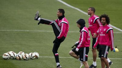Real Madrid's Cristiano Ronaldo kicks in the air followed by teammates Luka Modric, second left, and Marcelo during their Saturday training session for the Barcelona match on Sunday. Paul Hanna / Reuters
