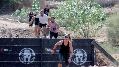 The runners jump into a ditch.