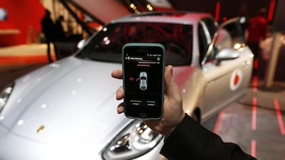 An engineer shows an app on his smartphone providing control over several functions of a Porsche connected car registered with the app on the Vodafone. Morris Mac Matzen / Reuters