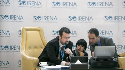 Attendees prepare before the full-day opening programme at the International Renewable Energy Agency. Silvia Razgova / The National