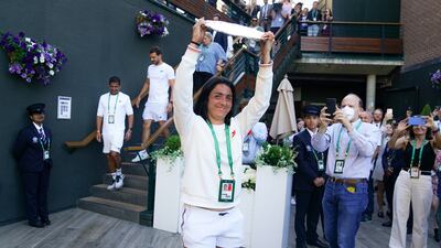 Ons Jabeur greets her supporters with the runners-up Wimbledon trophy. PA