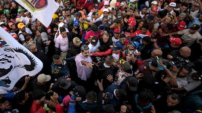 Venezuela's President Nicolas Maduro is surrounded at a rally marking Youth Day in Caracas, where he asked people in the US to unite with his country to ensure peace in the Americas. AFP