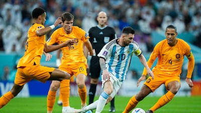 Argentina's Lionel Messi, second right, vies for the ball with Netherlands' defenders during the World Cup quarterfinal soccer match between the Netherlands and Argentina, at the Lusail Stadium in Lusail, Qatar, Friday, Dec. 9, 2022. (AP Photo / Francisco Seco)
