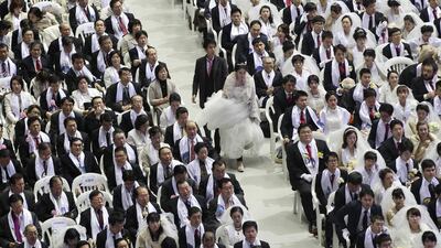 A couple arrives to attend a mass wedding ceremony at the Cheong Shim Peace World Center in Gapyeong, South Korea. 3,800 couples from more than fifty countries exchanged or reaffirmed marriage vows in the Unification Church’s mass wedding arranged by Hak Ja Han Moon, wife of the late Rev. Sun Myung Moon, the controversial founder of the church. Ahn Young-joon / AP photo