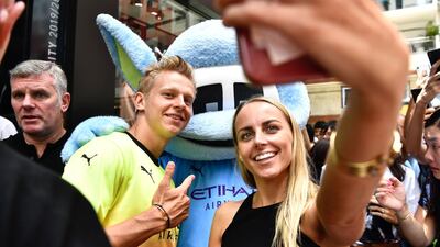 Oleksandr Zinchenko takes a selfie with a fan during a promotional event in Hong Kong. AFP