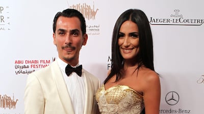 Syrian designer Rami Al Ali (L) and an unidentified guest arrive at the opening ceremony of the Abu Dhabi Film Festival (ADFF 2011) in Abu Dhabi, United Arab Emirates, 13 October 2011. ADFF 2011 will screen more than 200 films representing 43 countries. ???