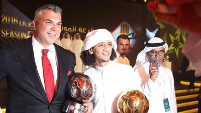Cosmin Olaroiu, left, poses with his Coach of the Year award alongside Emirati Player of the Year Omar Abdulrahman. Pawan Singh / The National