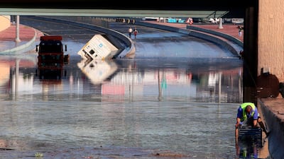 Municipality workers try to drain a flooded underpass in Kuwait City. AFP
