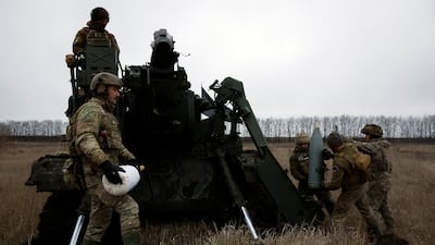 Ukrainian soldiers prepare to fire a cannon near the front line in Bakhmut. Reuters