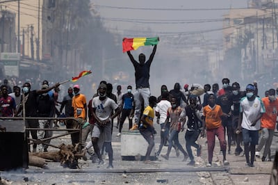 A demonstrator holds up a Senegalese flag during protests against the arrest of opposition leader and former presidential candidate Ousmane Sonko in Dakar, Senegal. AP